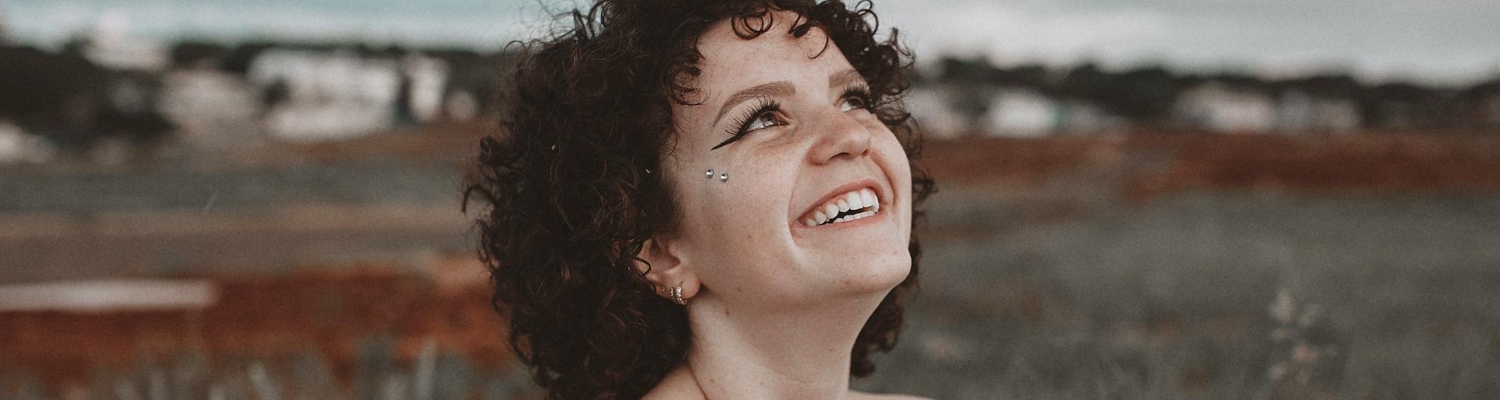 a happy woman looking at the sky,  